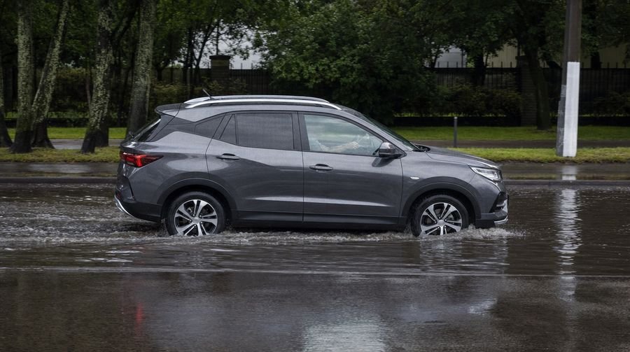 Car crossing a deep puddle slowly